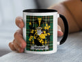 Mug with Abraham family crest on green plaid background.