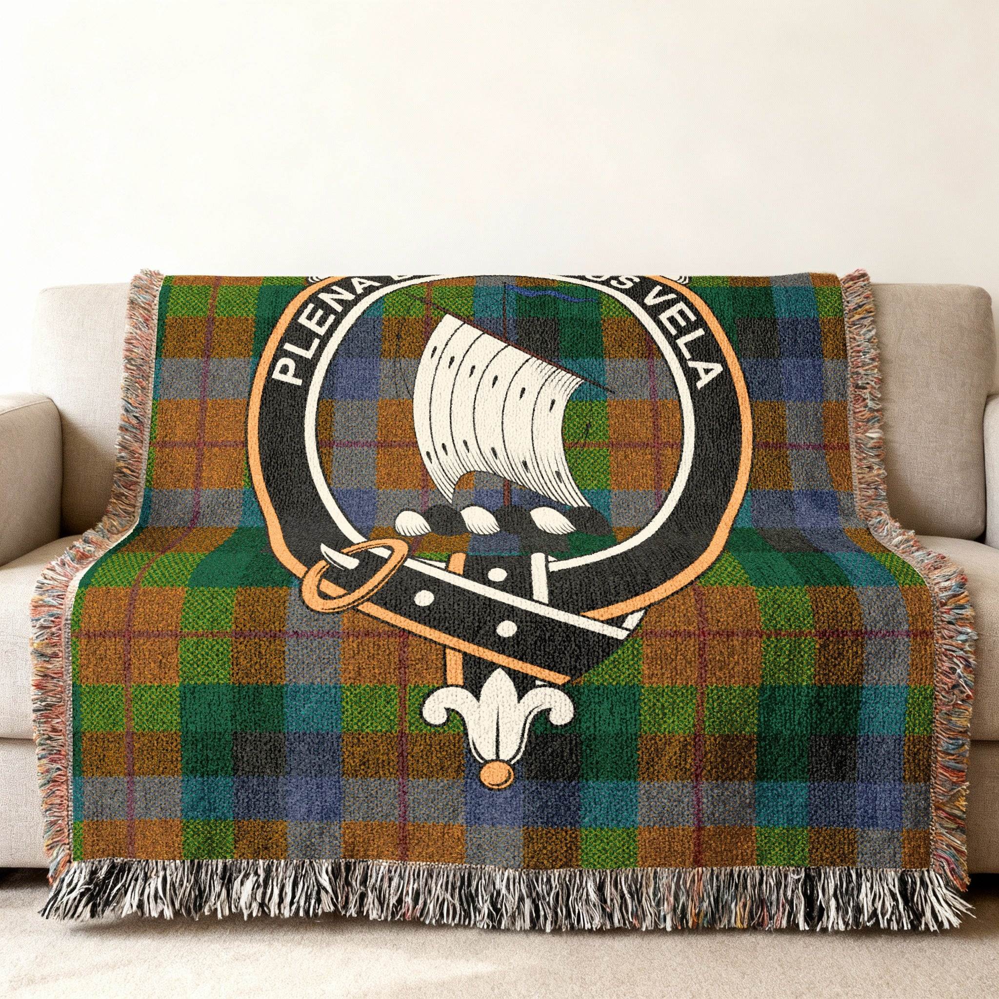 Clan Tennant crest plaid woven blanket with fringe edges — sofa display