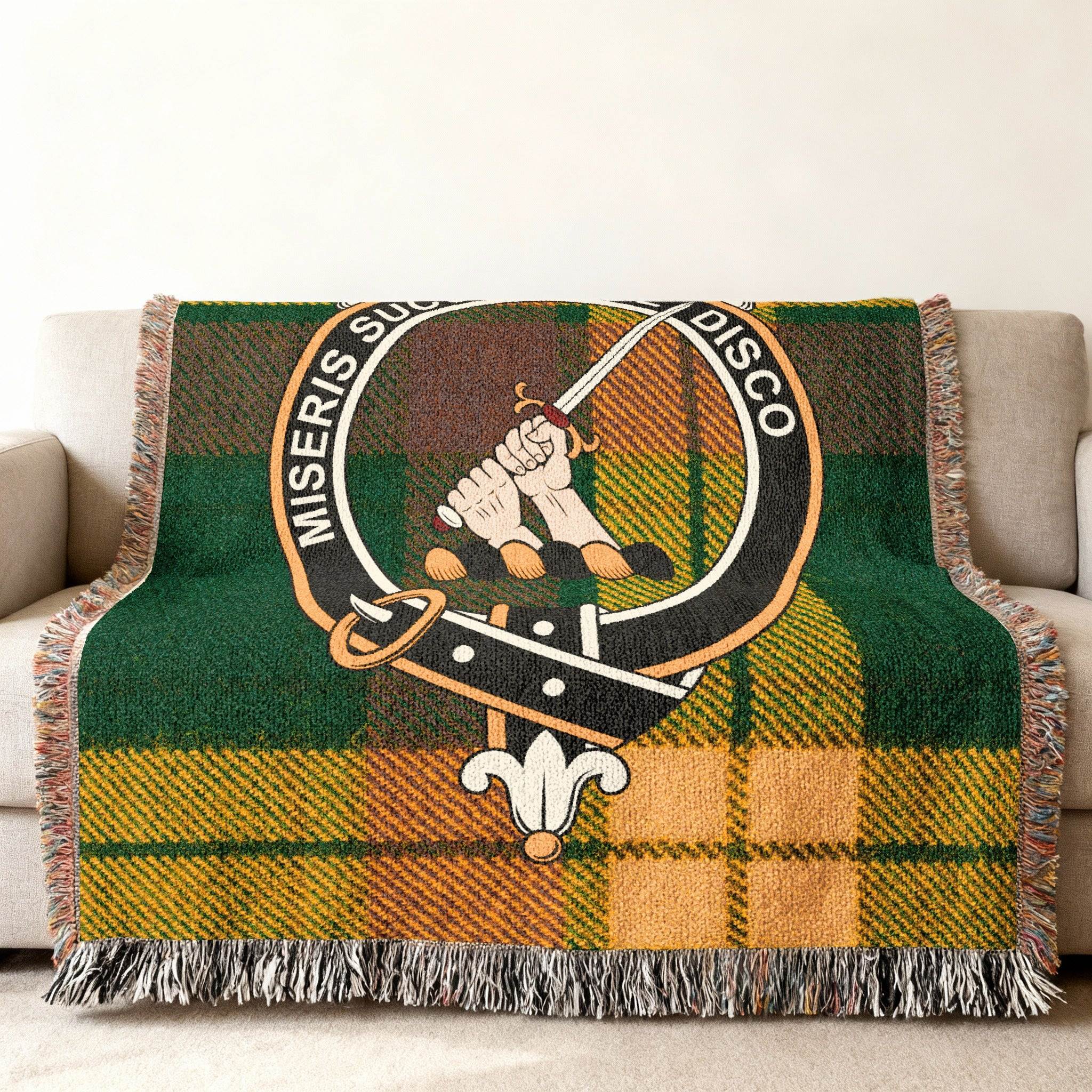 MacMillan clan crest detail on woven tartan blanket — full colour cotton construction