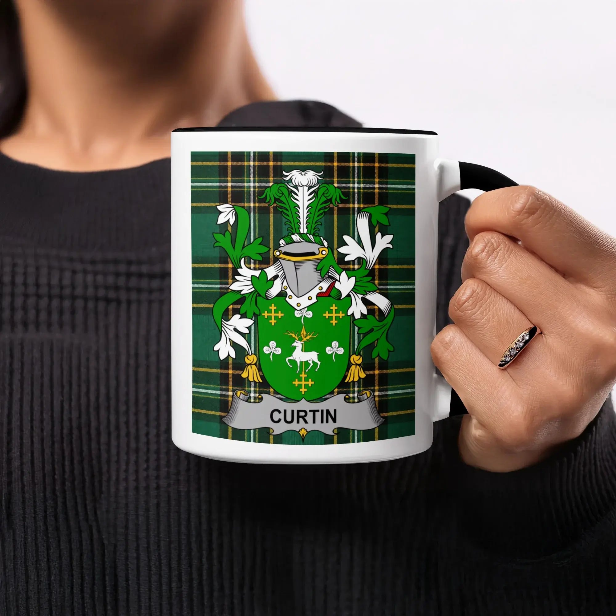 Mug with Curtin family crest on green tartan background.