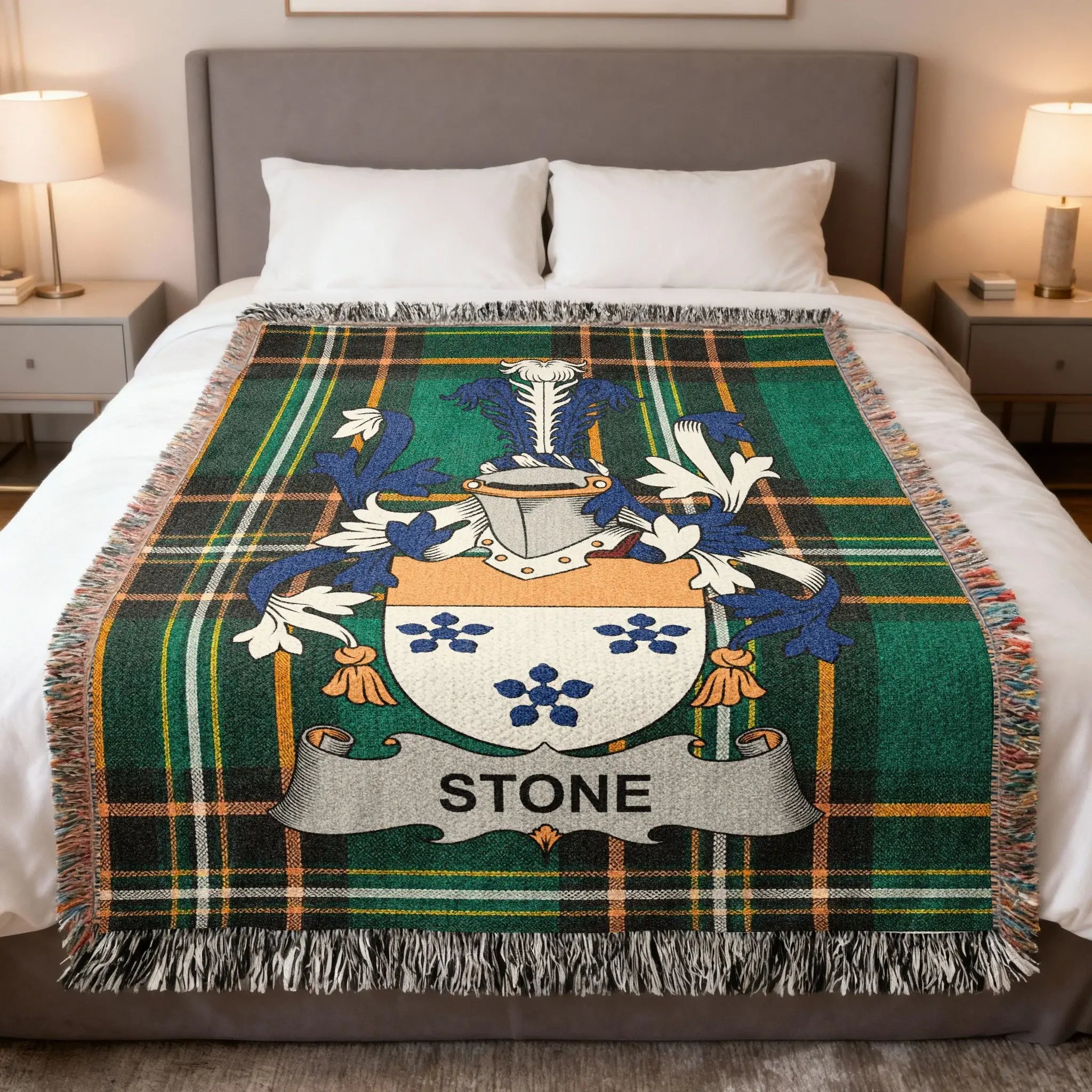 Stone family crest on a green tartan plaid throw blanket.