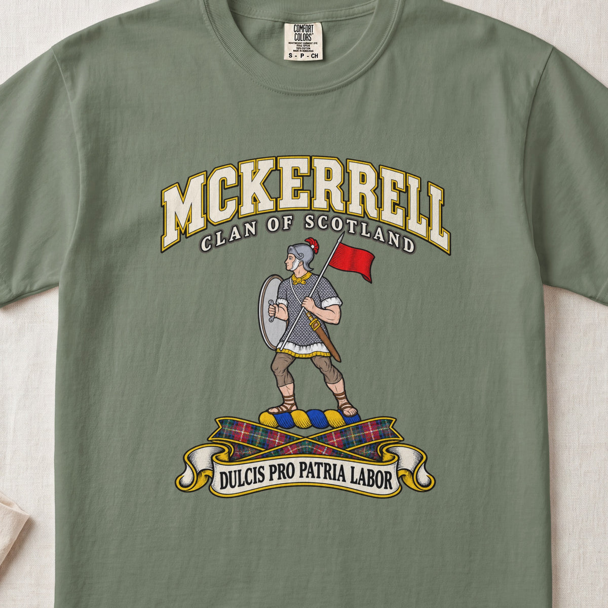 McKerrell Scottish clan T-shirt in Moss, front view with an armoured figure carrying a shield and red flag and motto banner.