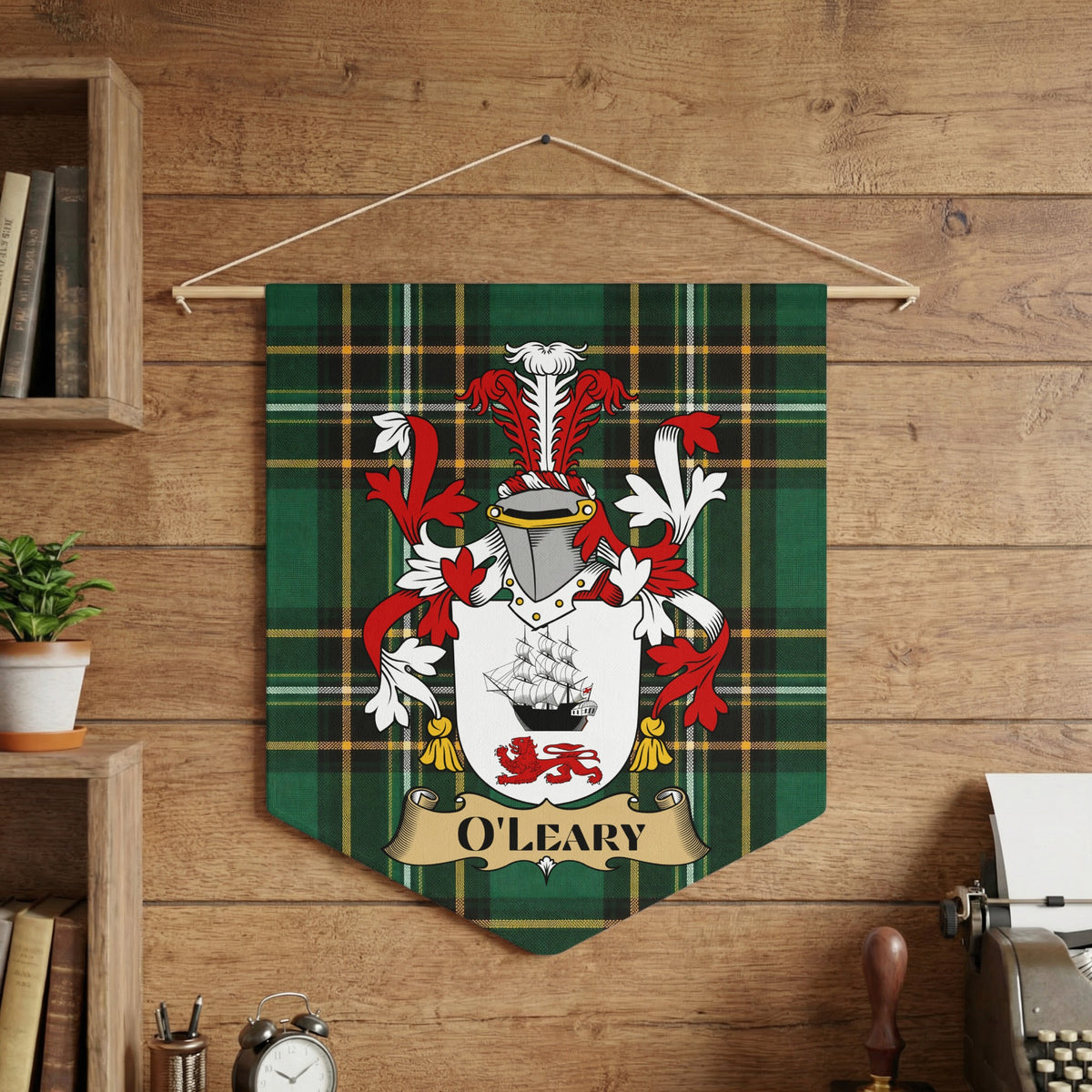 O'LEARY family crest on a green plaid pennant, displayed on a wooden wall.