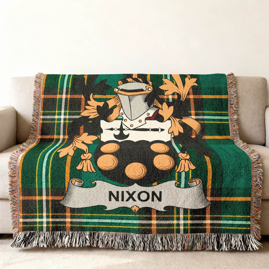 Green plaid throw blanket featuring the Nixon family crest with a shield and banner.