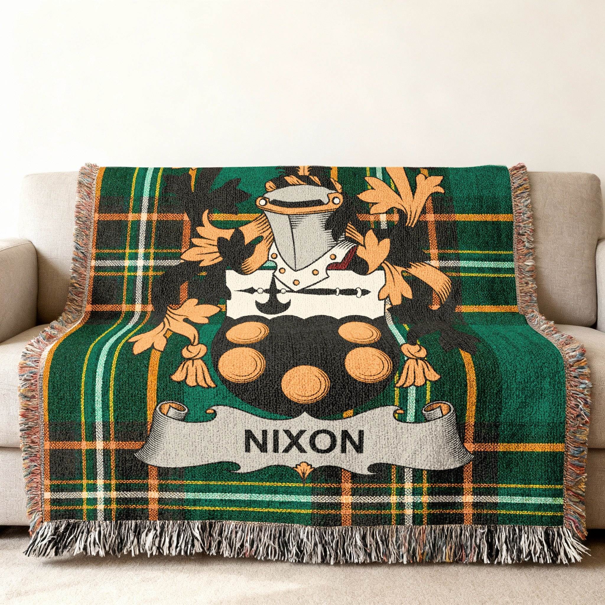 Green plaid throw blanket featuring the Nixon family crest with a shield and banner.