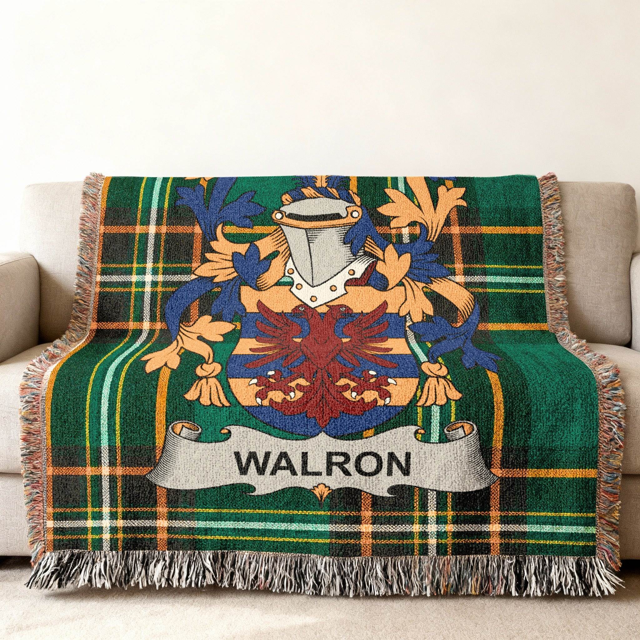 Walron family crest on a green tartan plaid throw blanket.