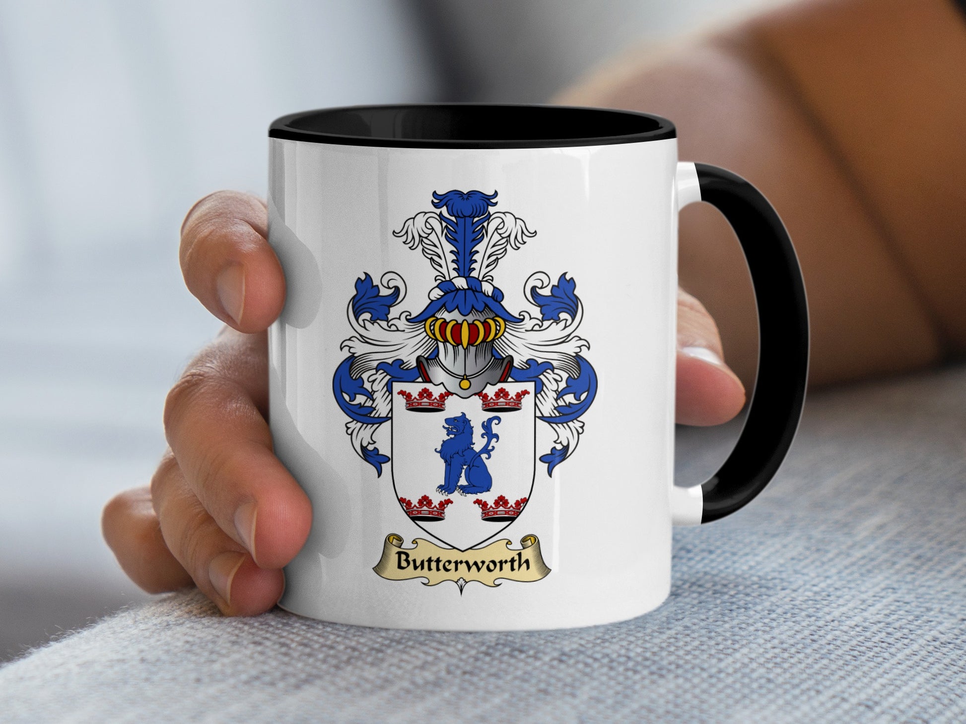 White mug with black rim featuring the Butterworth family crest.