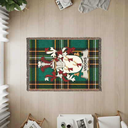 Woven blanket with green, black, and yellow plaid featuring the VIGORS coat of arms.