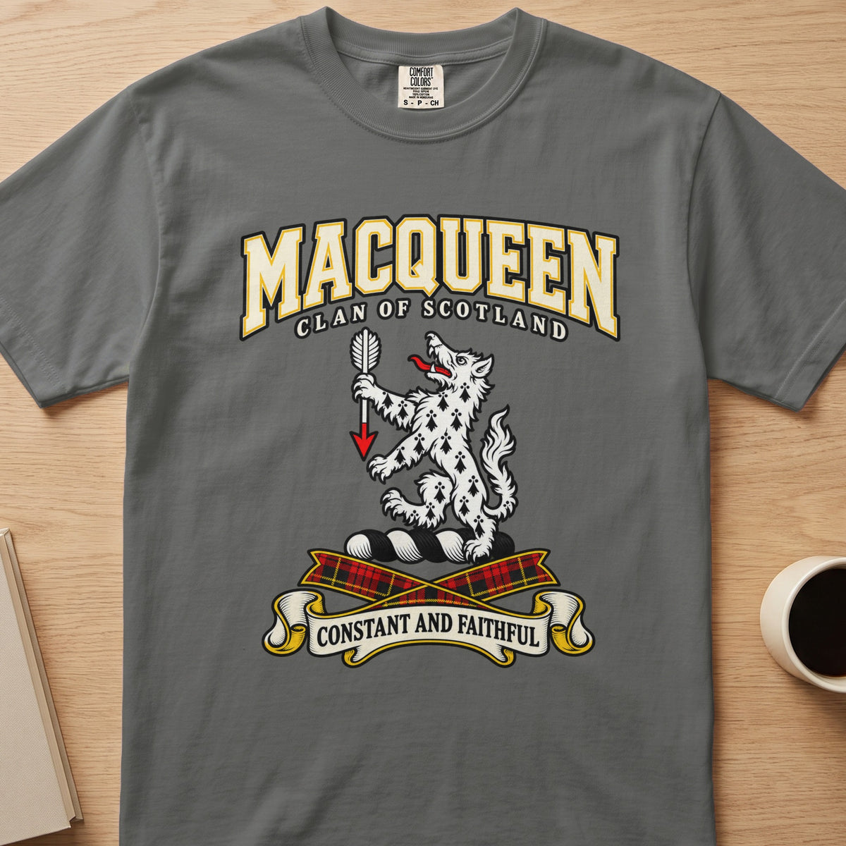 MacQueen white spotted animal crest graphic on a charcoal gray Comfort Colors T-shirt, front view