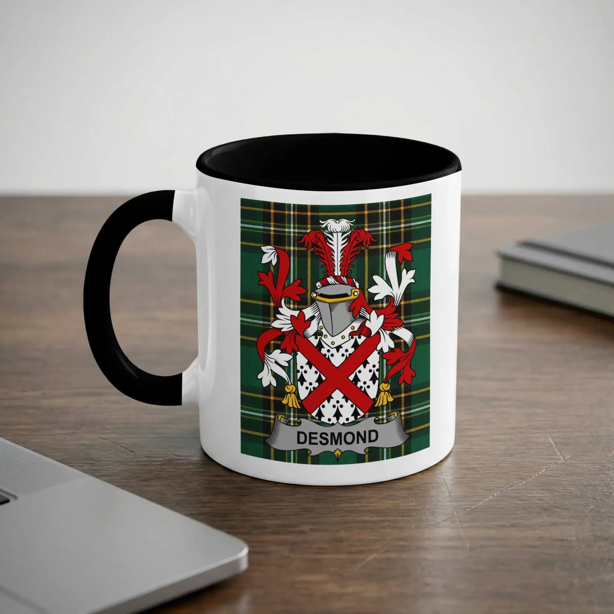 White mug with black handle featuring the Desmond family crest on a tartan background.