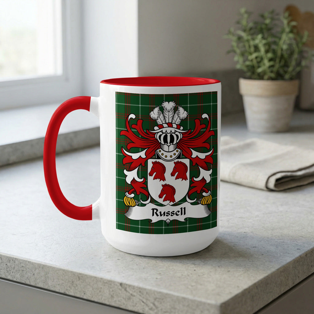 White mug with red handle and rim featuring the Russell family crest on a tartan background.