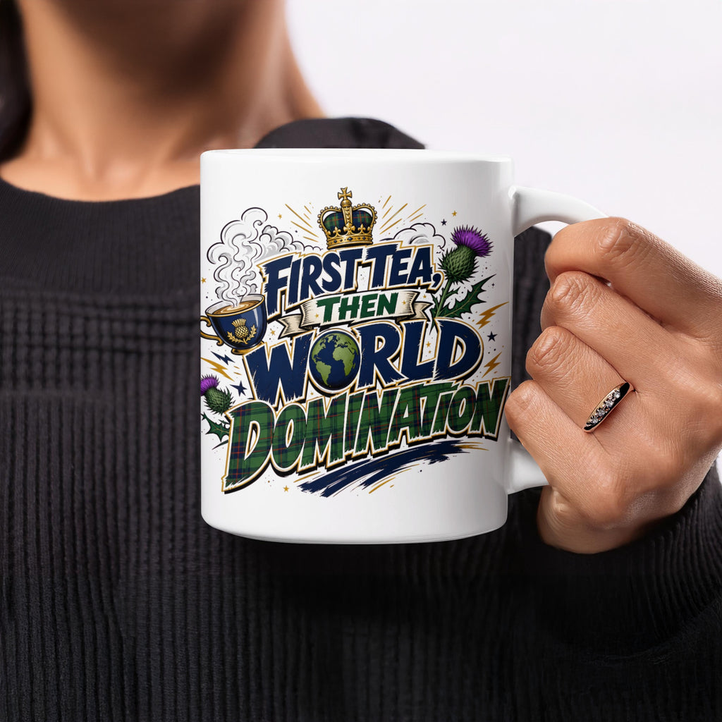 White mug with "First Tea Then World Domination" text and Scottish thistle design.