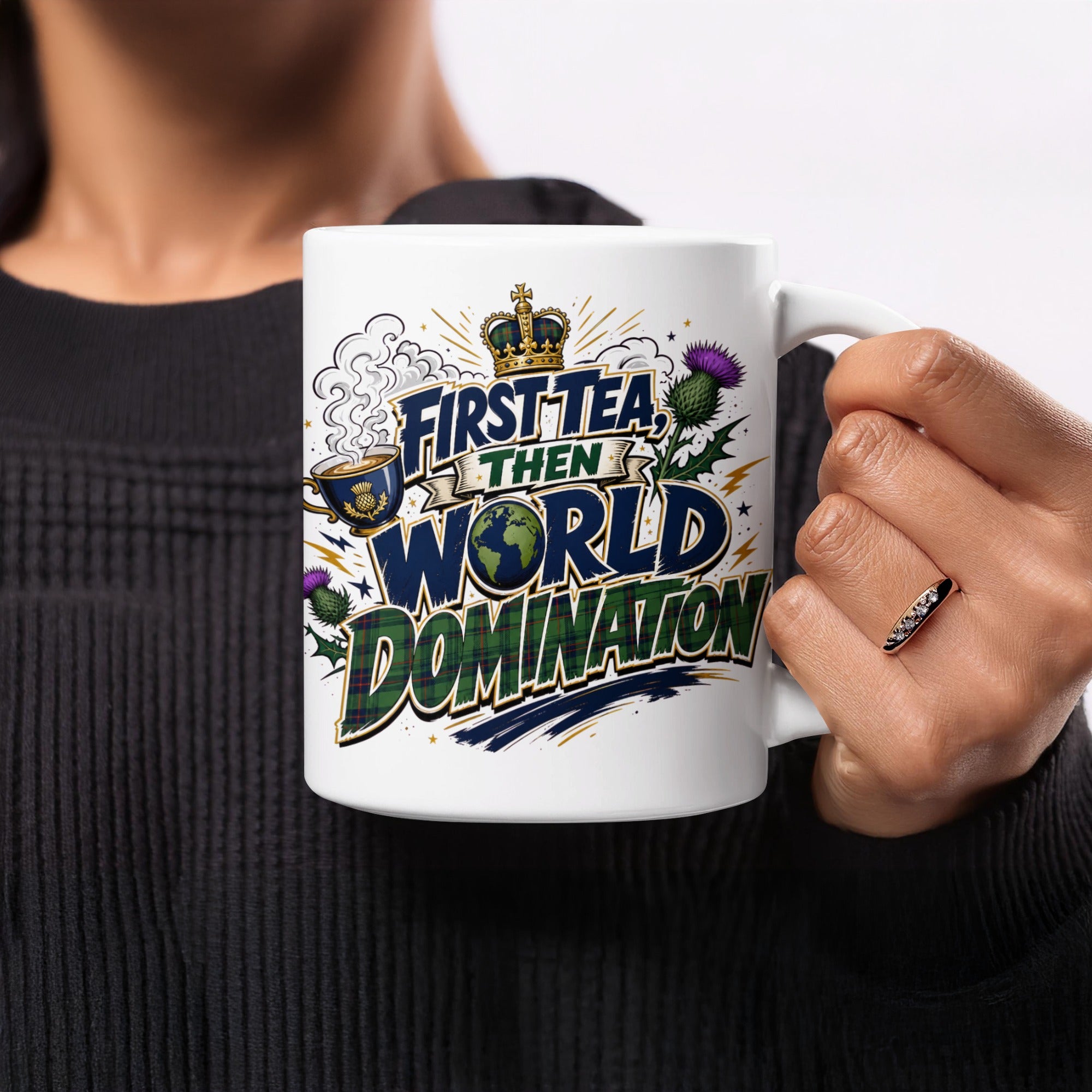 White mug with "First Tea Then World Domination" text and Scottish thistle design.