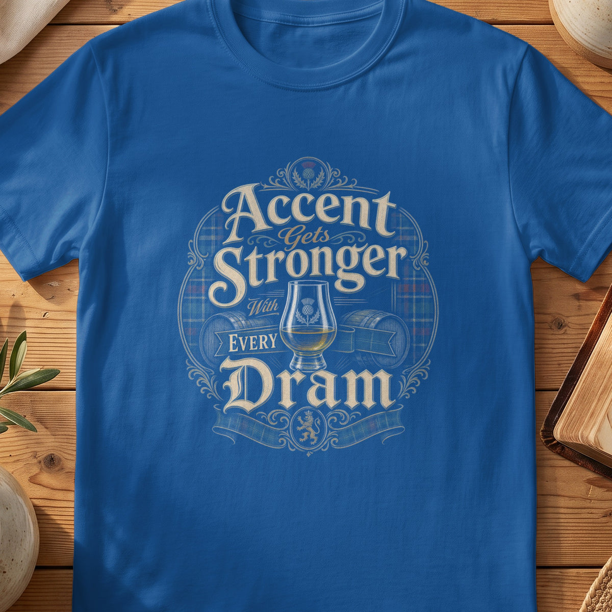 Blue t-shirt with distressed text "Accent Gets Stronger With Every Dram" and whisky elements.