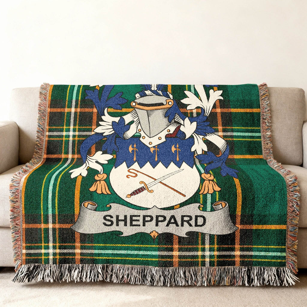 Green plaid throw blanket with Sheppard family crest.
