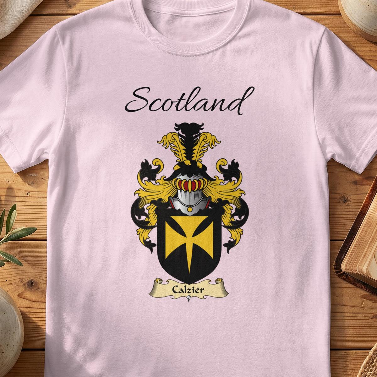 Light Pink Calzier Scottish family shield T-shirt featuring a gold cross motif on a black shield