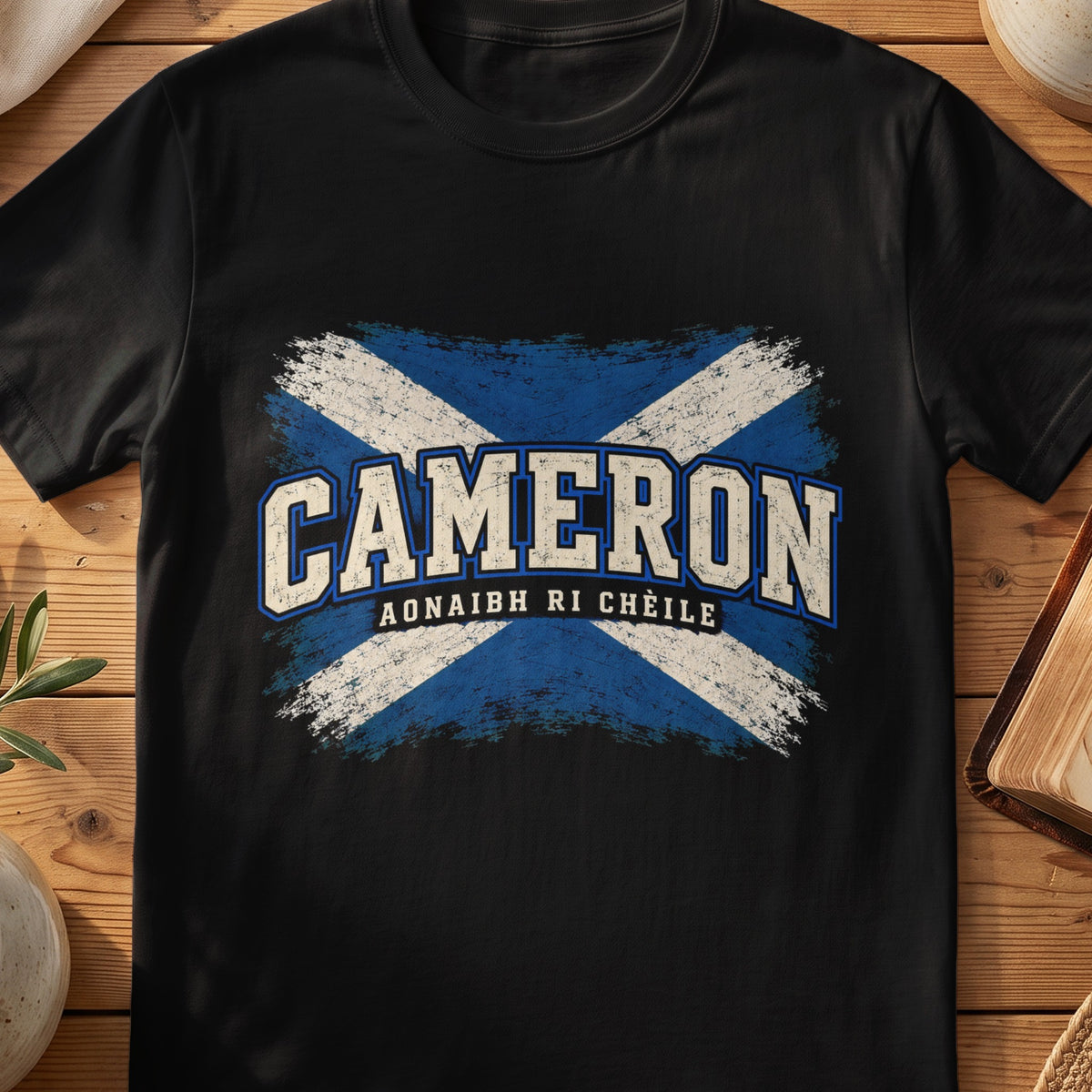 Cameron Scottish Saltire T-shirt in Black, with distressed blue and cream flag and “Aonaibh Ri Chèile” lettering.