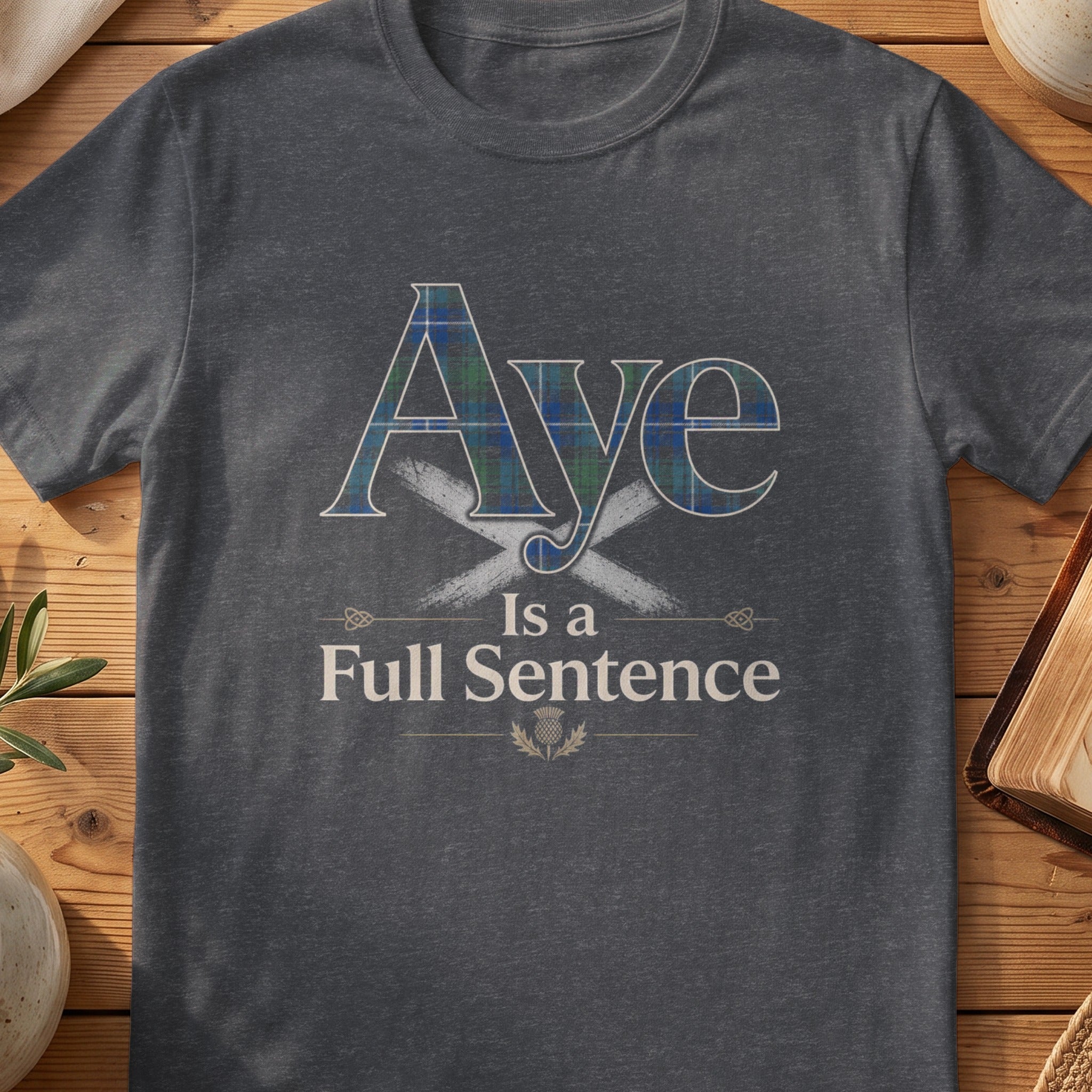 Dark grey Gildan 64000 unisex T-shirt flatlay with Aye Is a Full Sentence Scottish graphic design