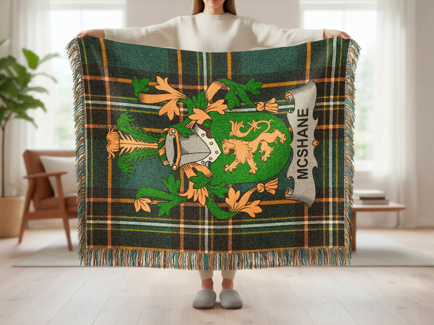 Green and orange tartan blanket with a family crest and "MCSHANE" text.