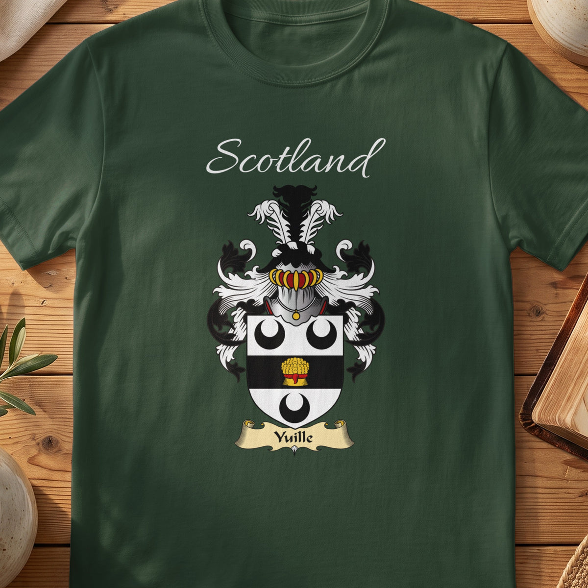 Forest Green Yuille Scottish T-shirt laid flat with coat of arms artwork and “Scotland” text.