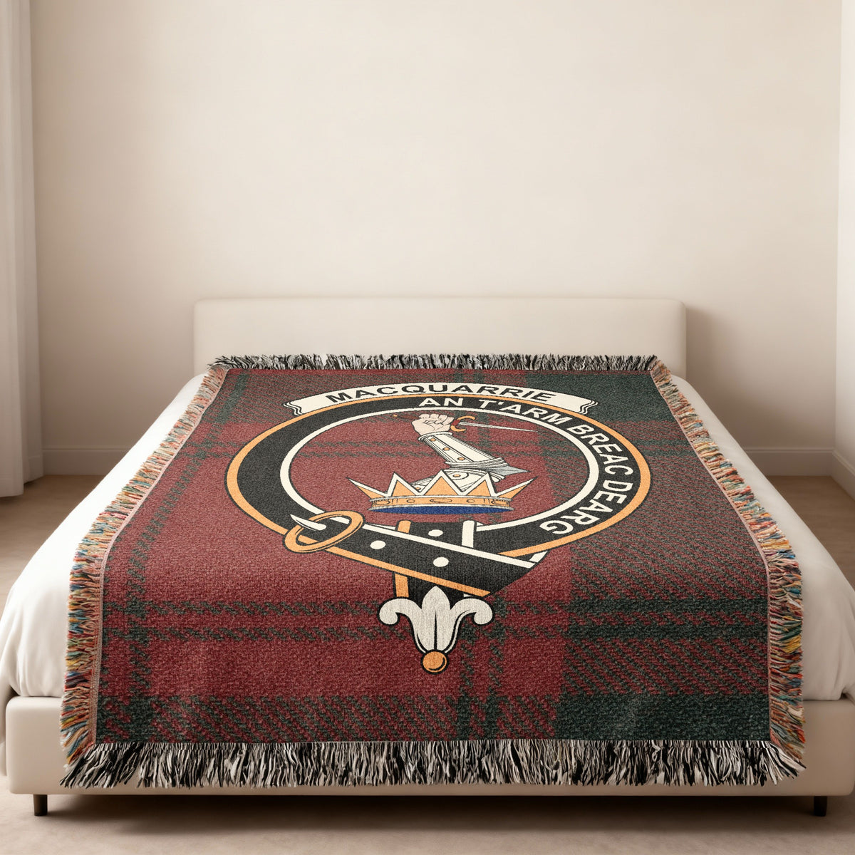 MacQuarrie Scottish woven blanket spread across a bed, showing the full crest design and tartan background
