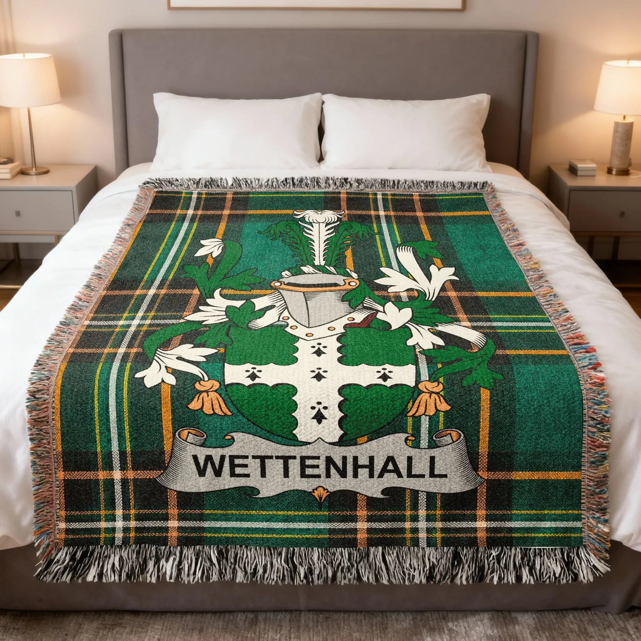Wettenhall family crest on a green plaid throw blanket draped on a bed.