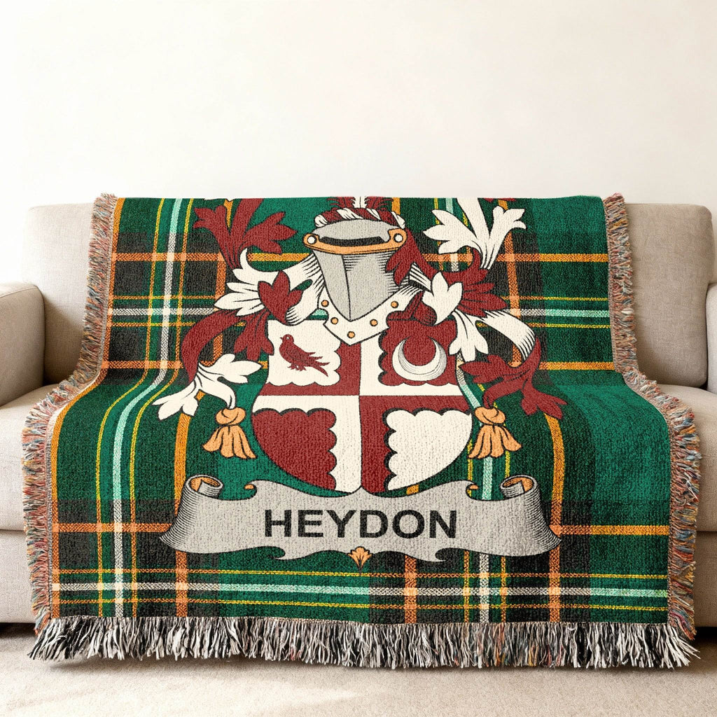 Plaid throw blanket with Heydon family crest in red, white, and green.