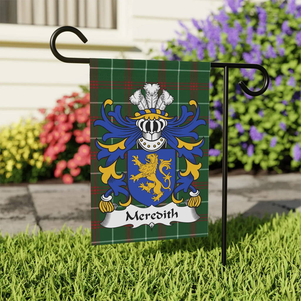 Green tartan flag with Meredith family crest and shield, displayed outdoors.