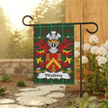 Watkins family crest on a tartan flag displayed on a garden pole.