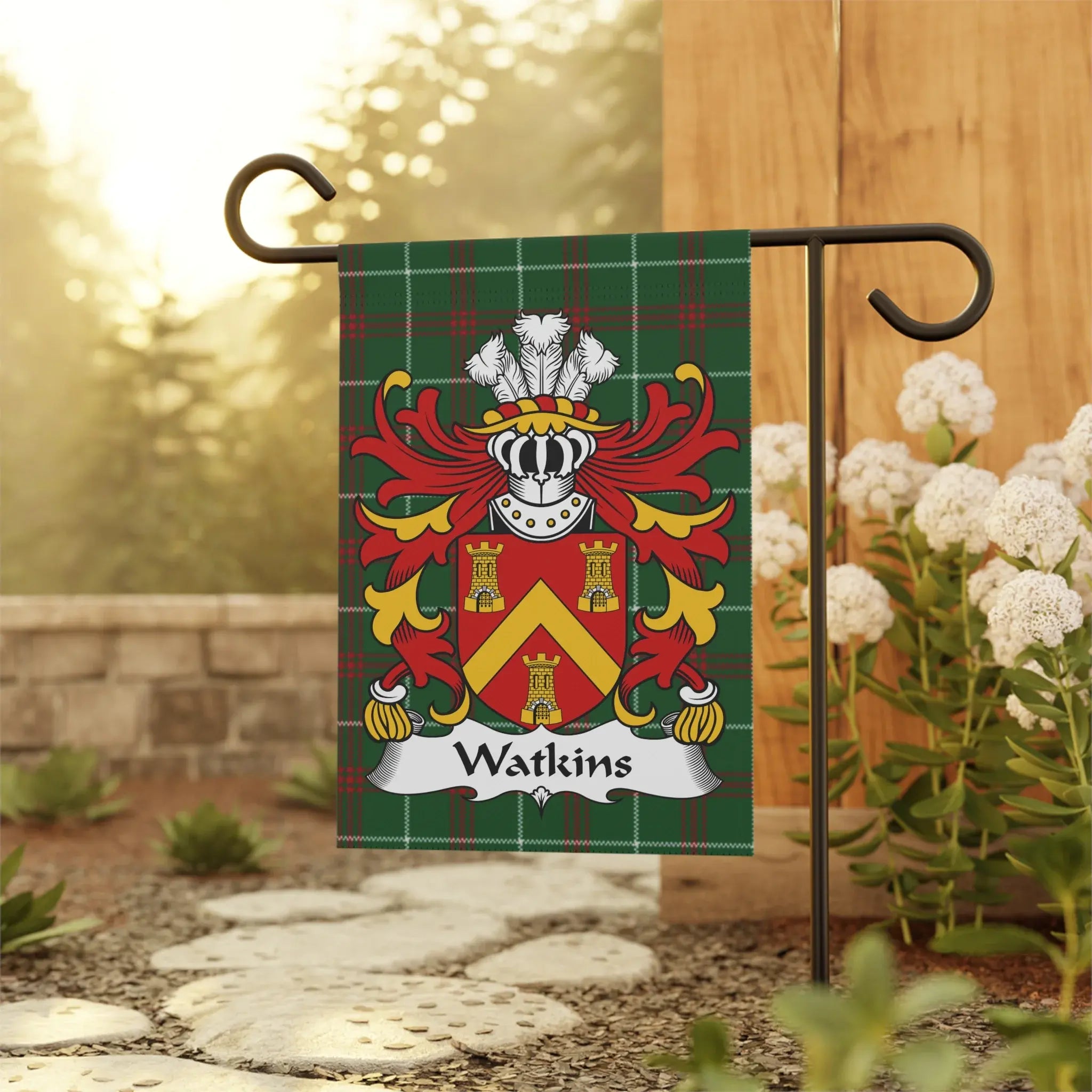 Watkins family crest on a tartan flag displayed on a garden pole.