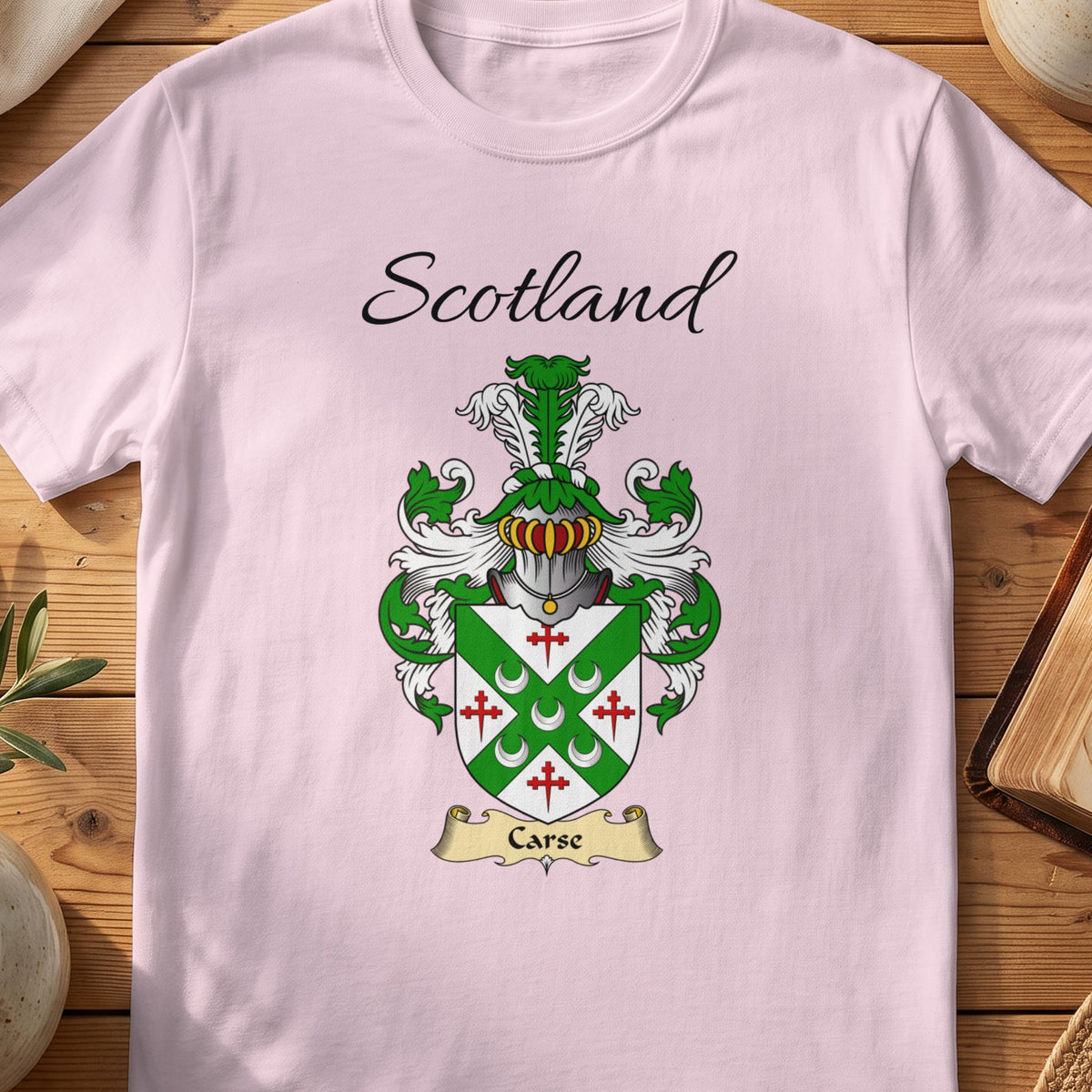 Light Pink Carse Scottish family shield T-shirt featuring a green diagonal cross with red cross motifs