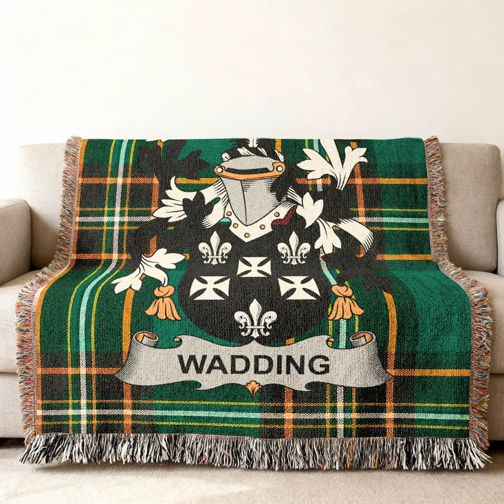 Wadding coat of arms on a green plaid woven throw blanket.