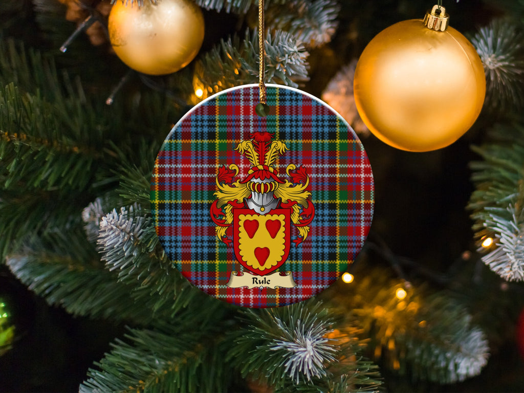 Rule family emblem ceramic Christmas ornament with Caledonia tartan background in festive holiday décor