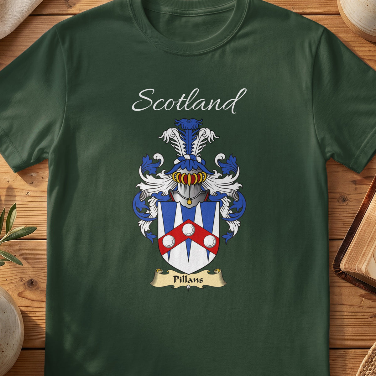 Forest Green Pillans Scottish T-shirt laid flat with coat of arms artwork and “Scotland” text.