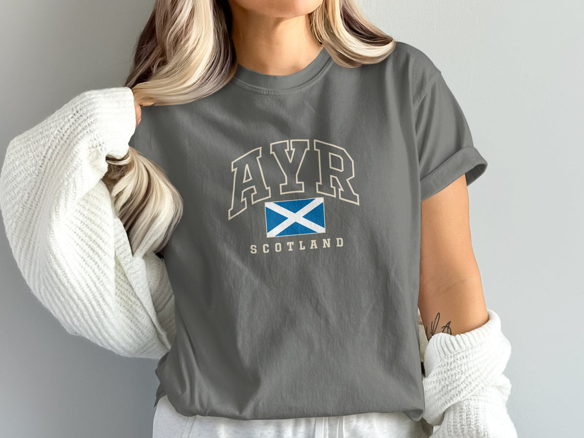 Model wearing the Pepper Ayr Scotland Comfort Colors T-shirt with cream collegiate lettering