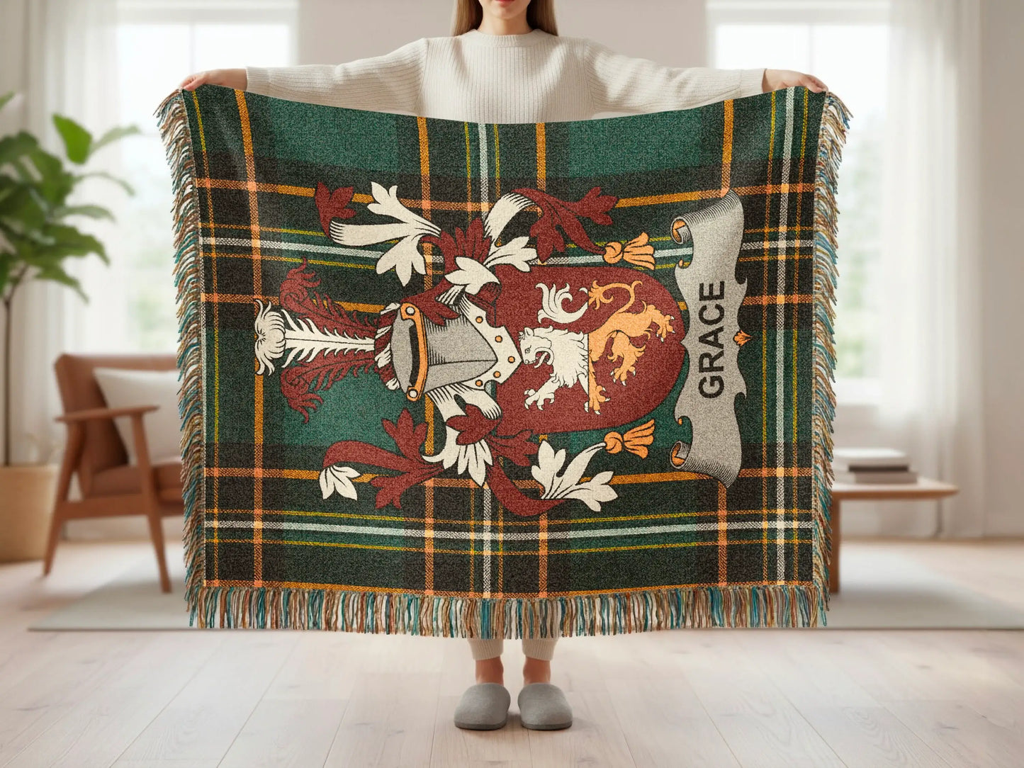 Tartan blanket with crest and "Grace" text held by person.