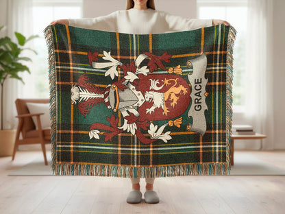 Tartan blanket with crest and "Grace" text held by person.