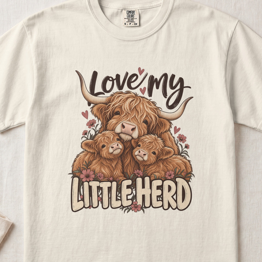 Love My Little Herd Highland cow design on an Ivory Comfort Colors 1717 T-shirt, flat lay