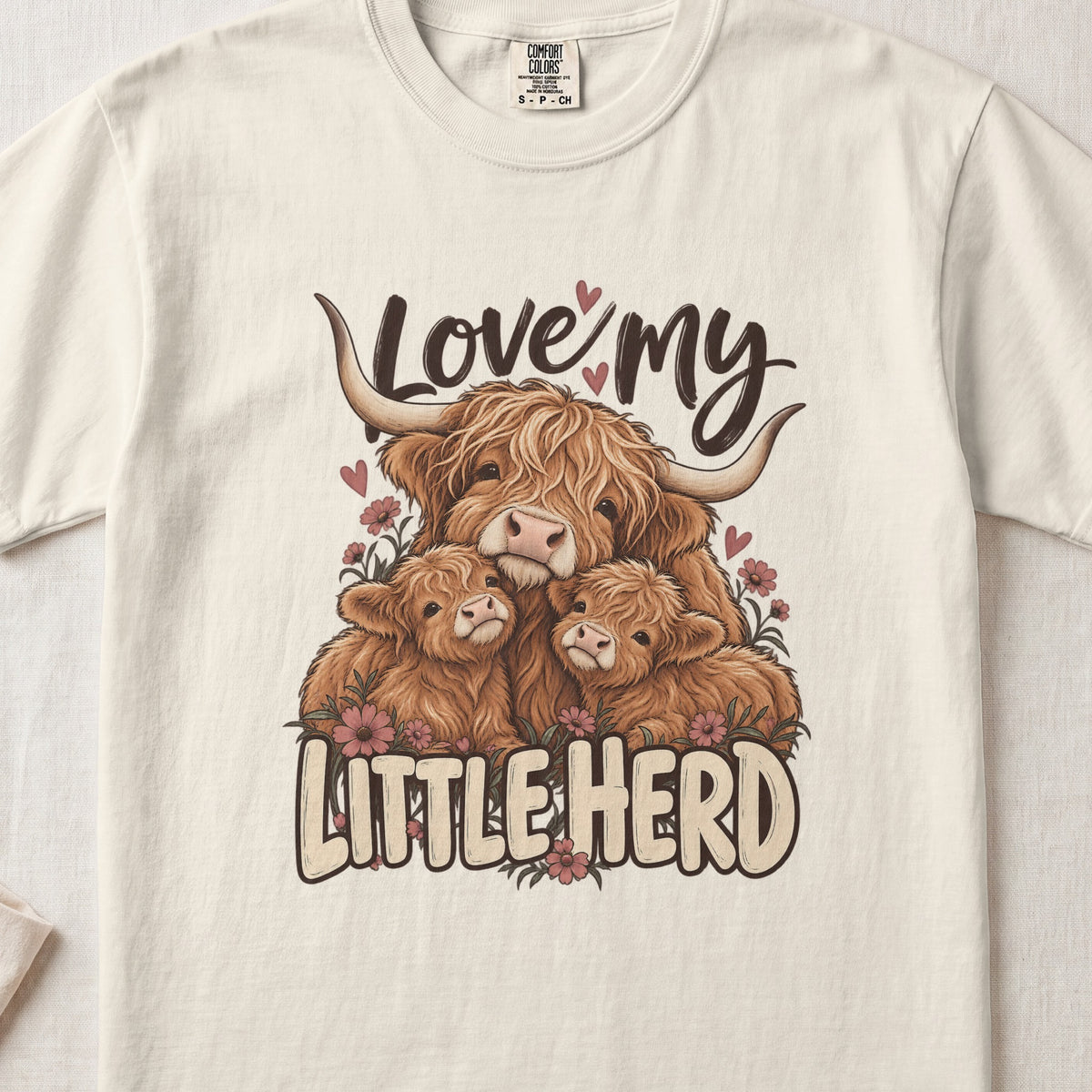 Love My Little Herd Highland cow design on an Ivory Comfort Colors 1717 T-shirt, flat lay