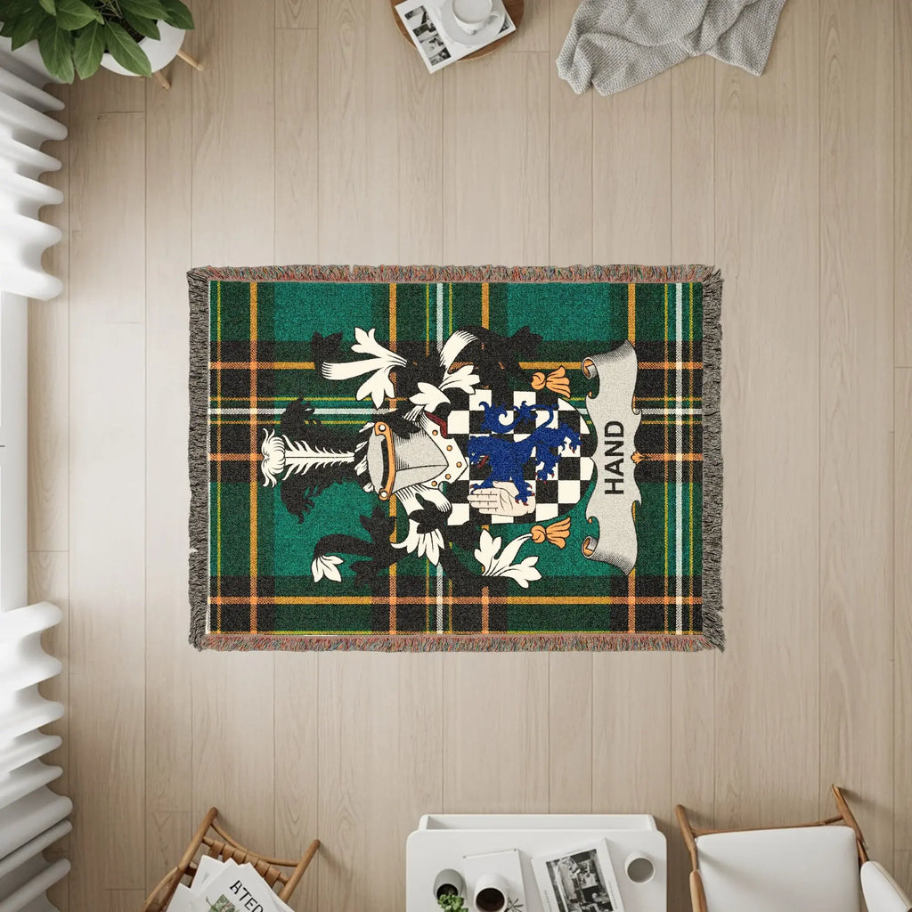 Woven throw blanket with green plaid and a family crest for Hand.
