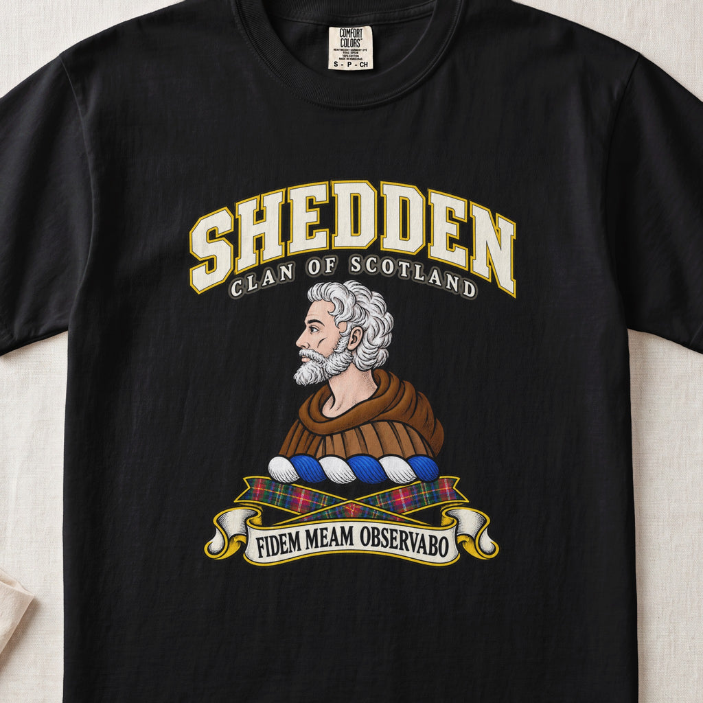 Shedden Scottish clan T-shirt in Black, front view with a gray-haired, bearded figure in a brown robe and motto design.