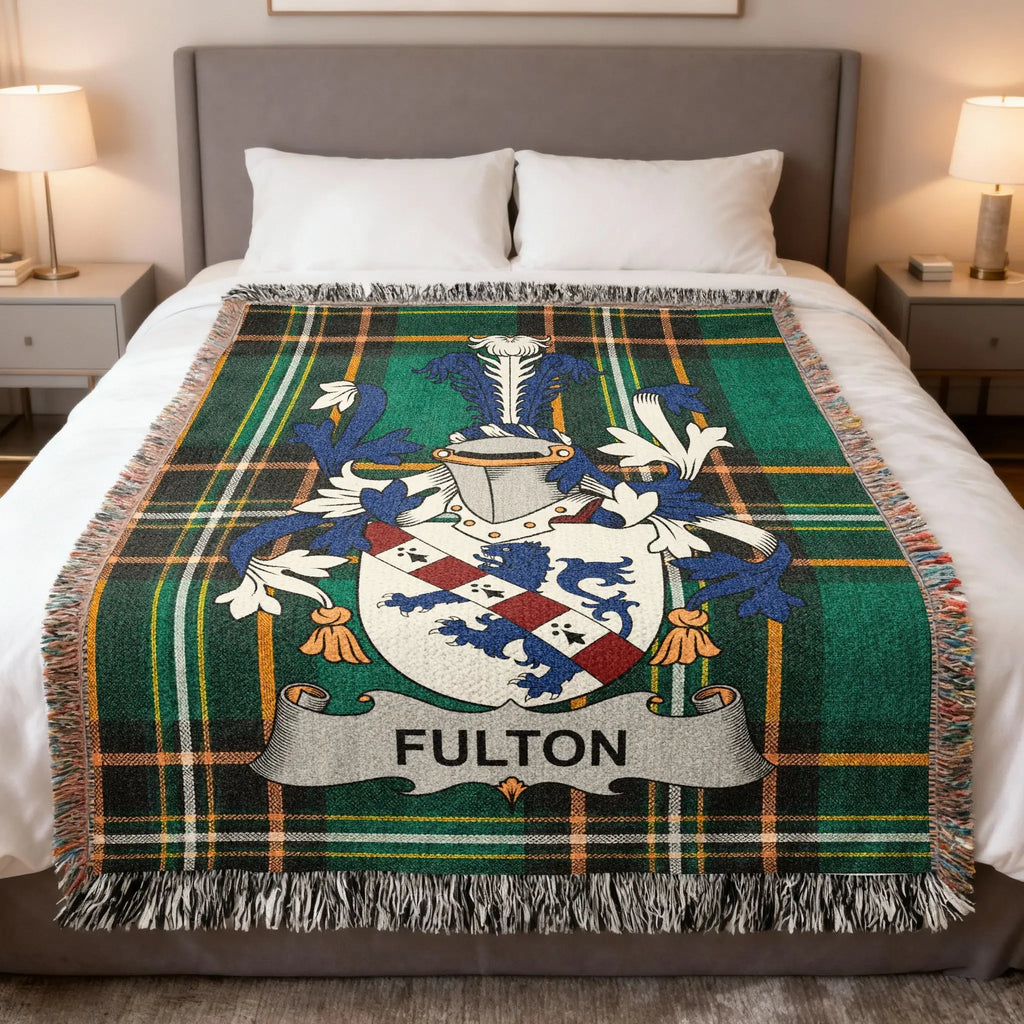 Fulton family crest on a green plaid blanket with white fringe.