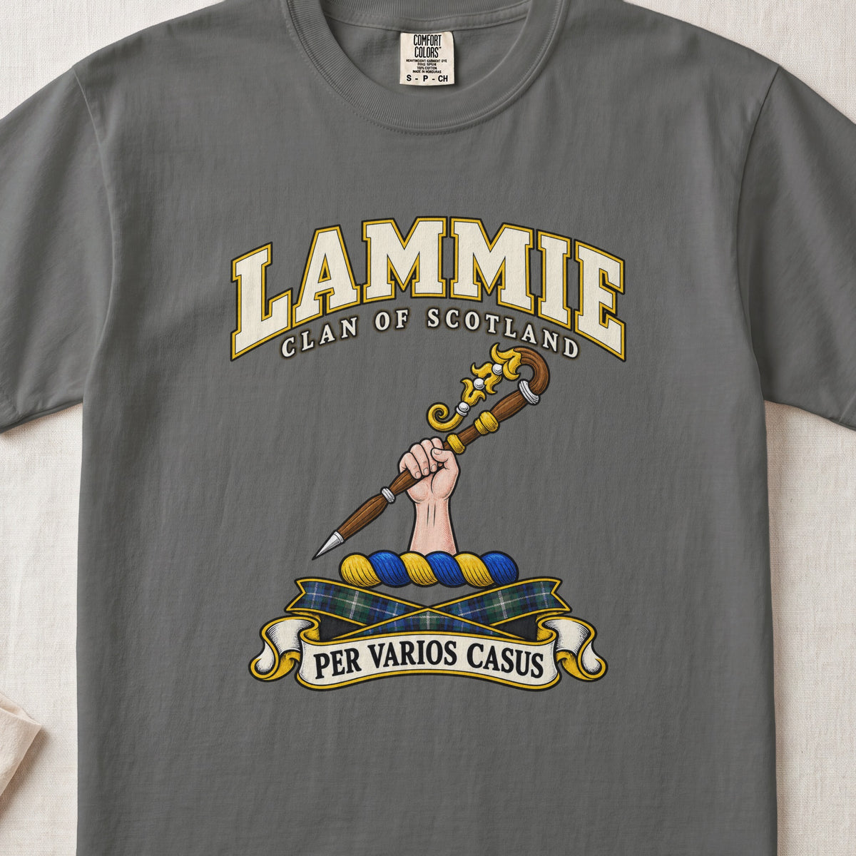Lammie Scottish clan T-shirt in Pepper, front view with a hand holding an ornate crozier and motto design.