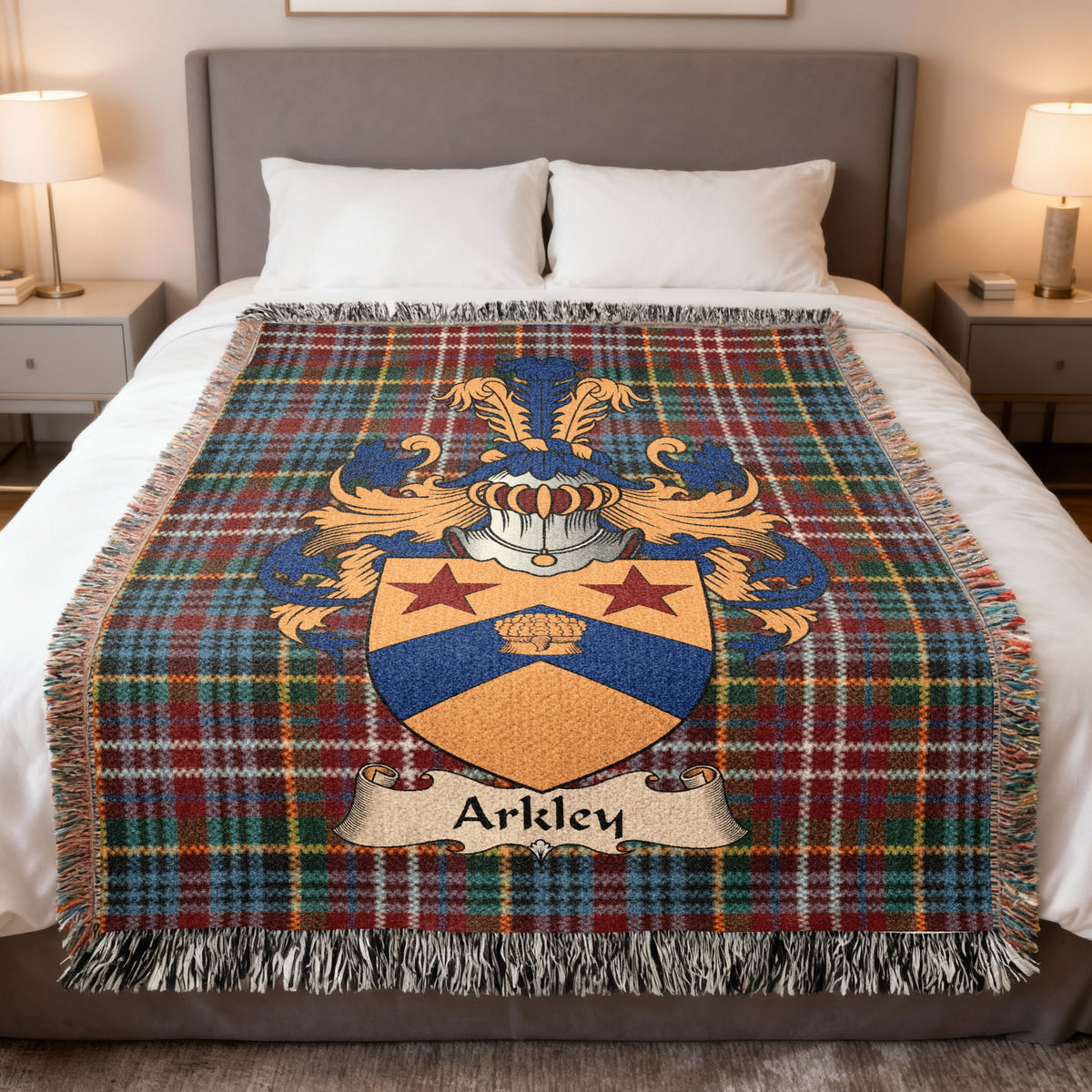 Arkley Scottish family crest woven blanket on a Caledonia tartan background, displayed on a bed