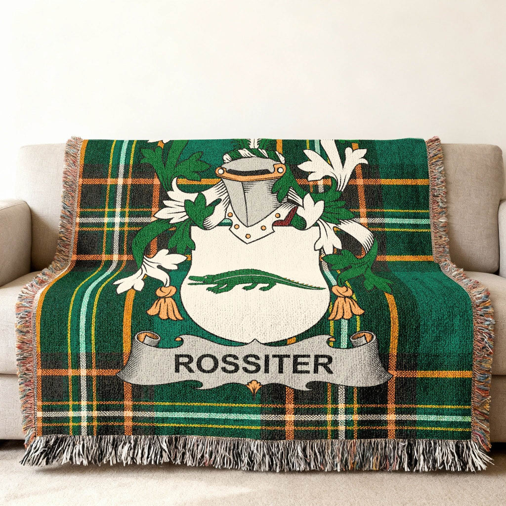 Rossiter family crest in green plaid throw blanket on a sofa.