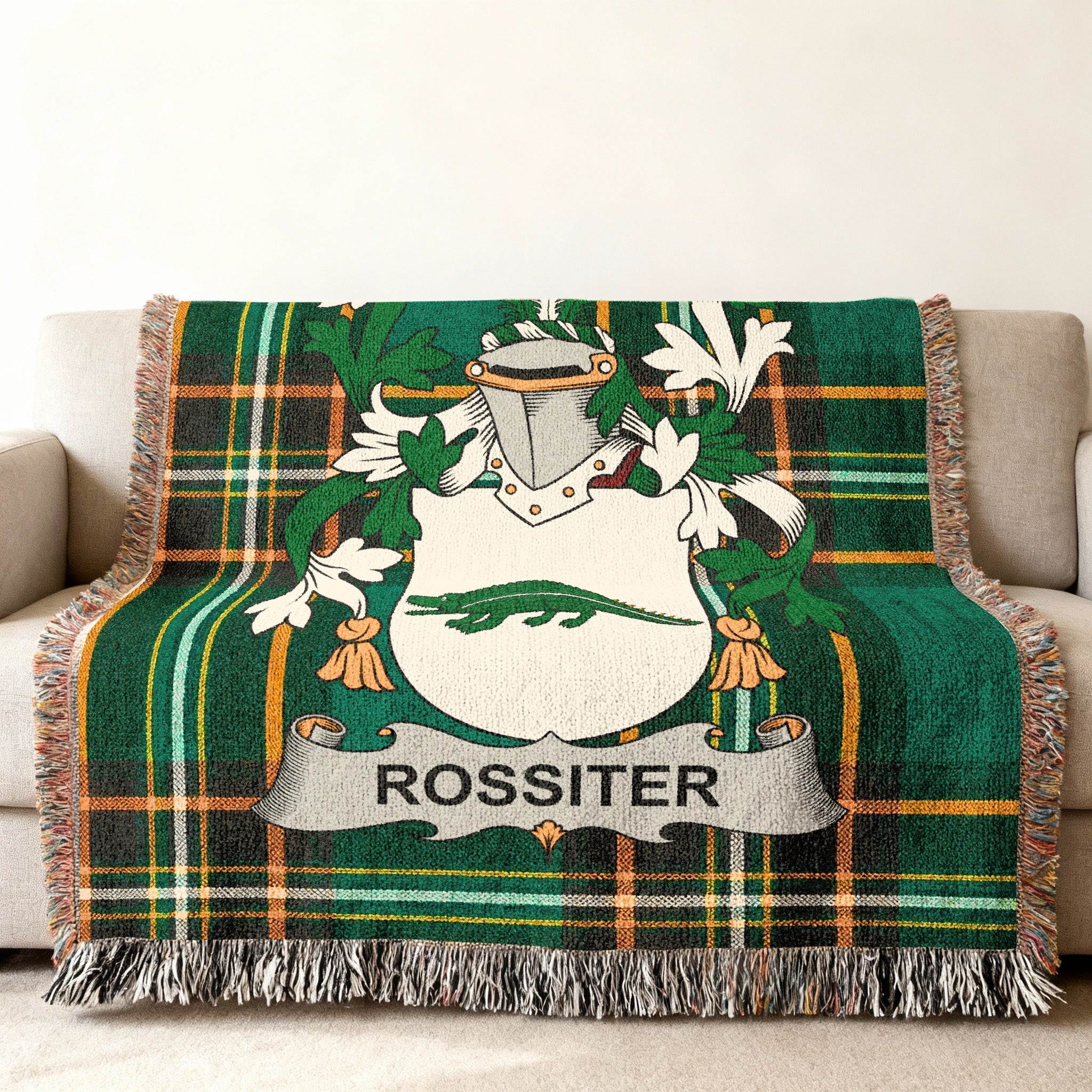 Rossiter family crest in green plaid throw blanket on a sofa.