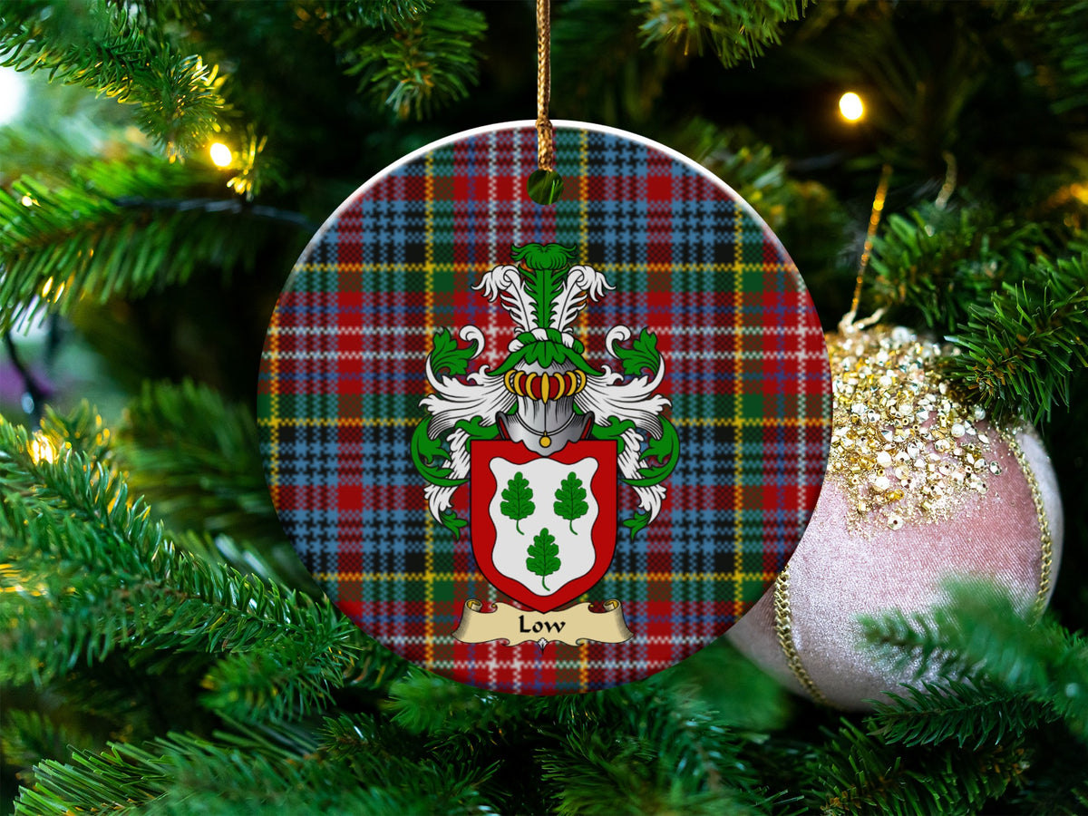 Low Scottish clan ceramic ornament with family crest on a Caledonia tartan background, hanging on a Christmas tree