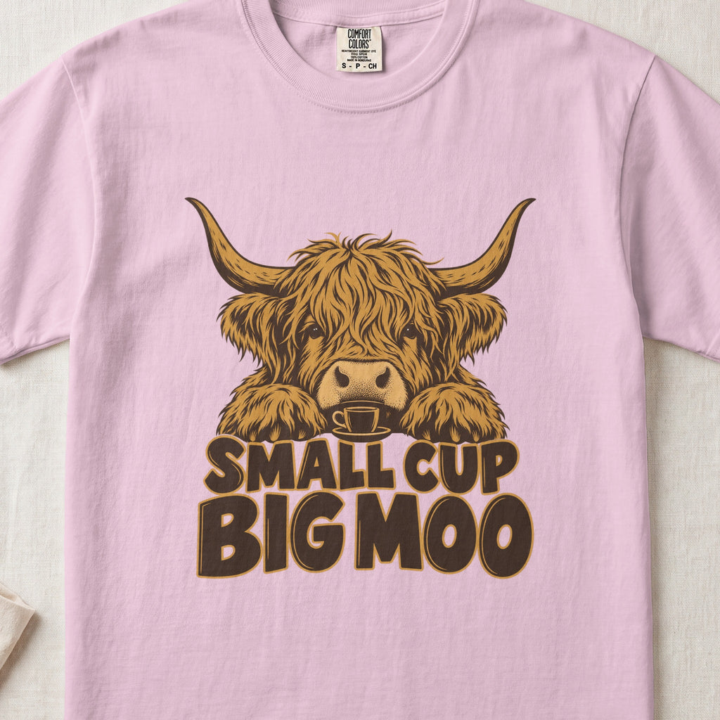 Small Cup, Big Moo Highland cow design on a Blossom Comfort Colors 1717 T-shirt, flat lay