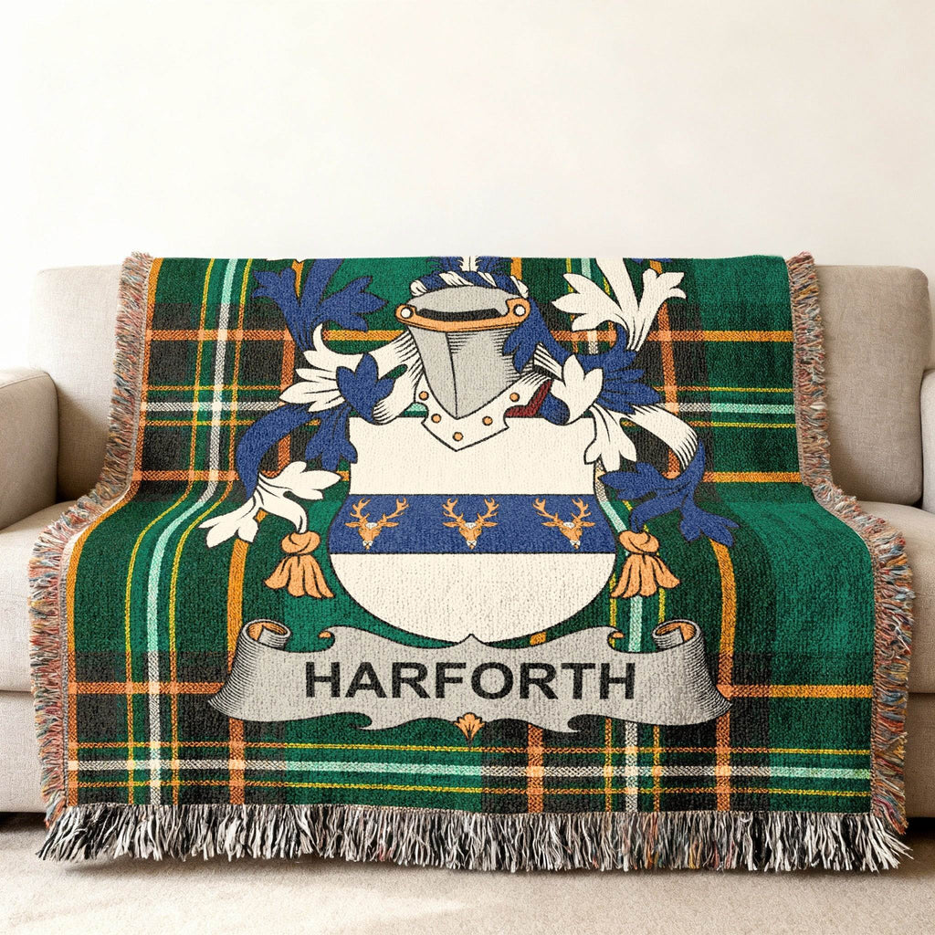 Harforth family crest on a green plaid throw blanket on a couch.