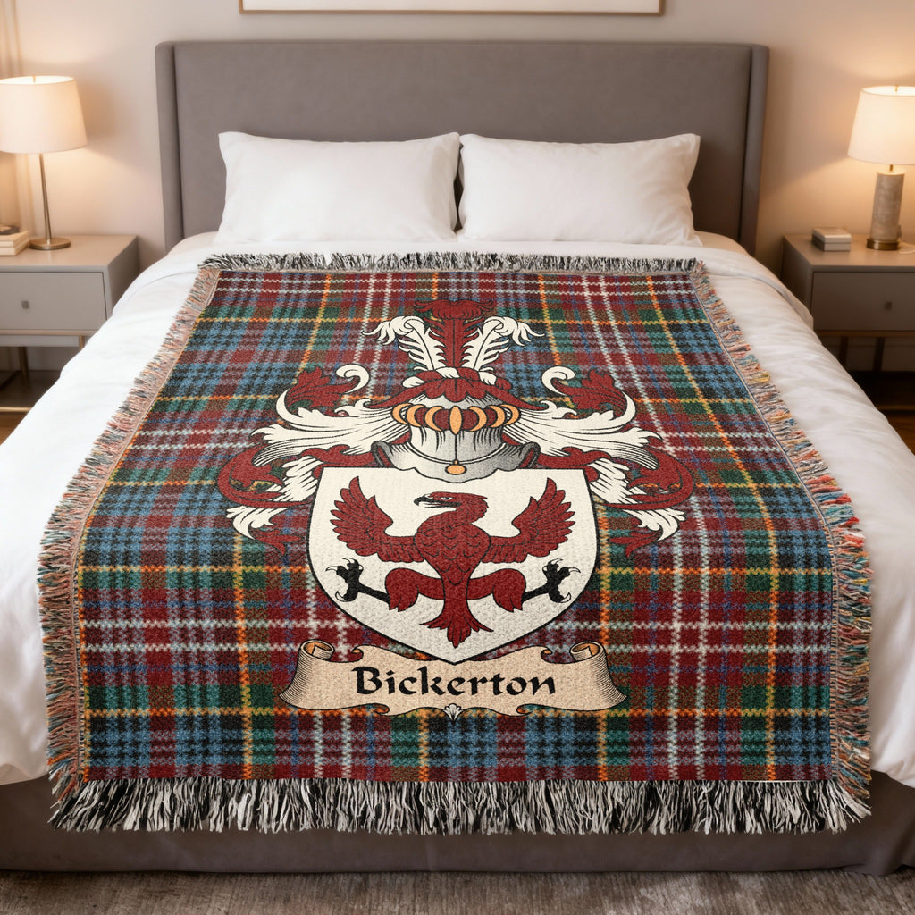 Bickerton Scottish family crest woven blanket on a Caledonia tartan background, displayed on a bed